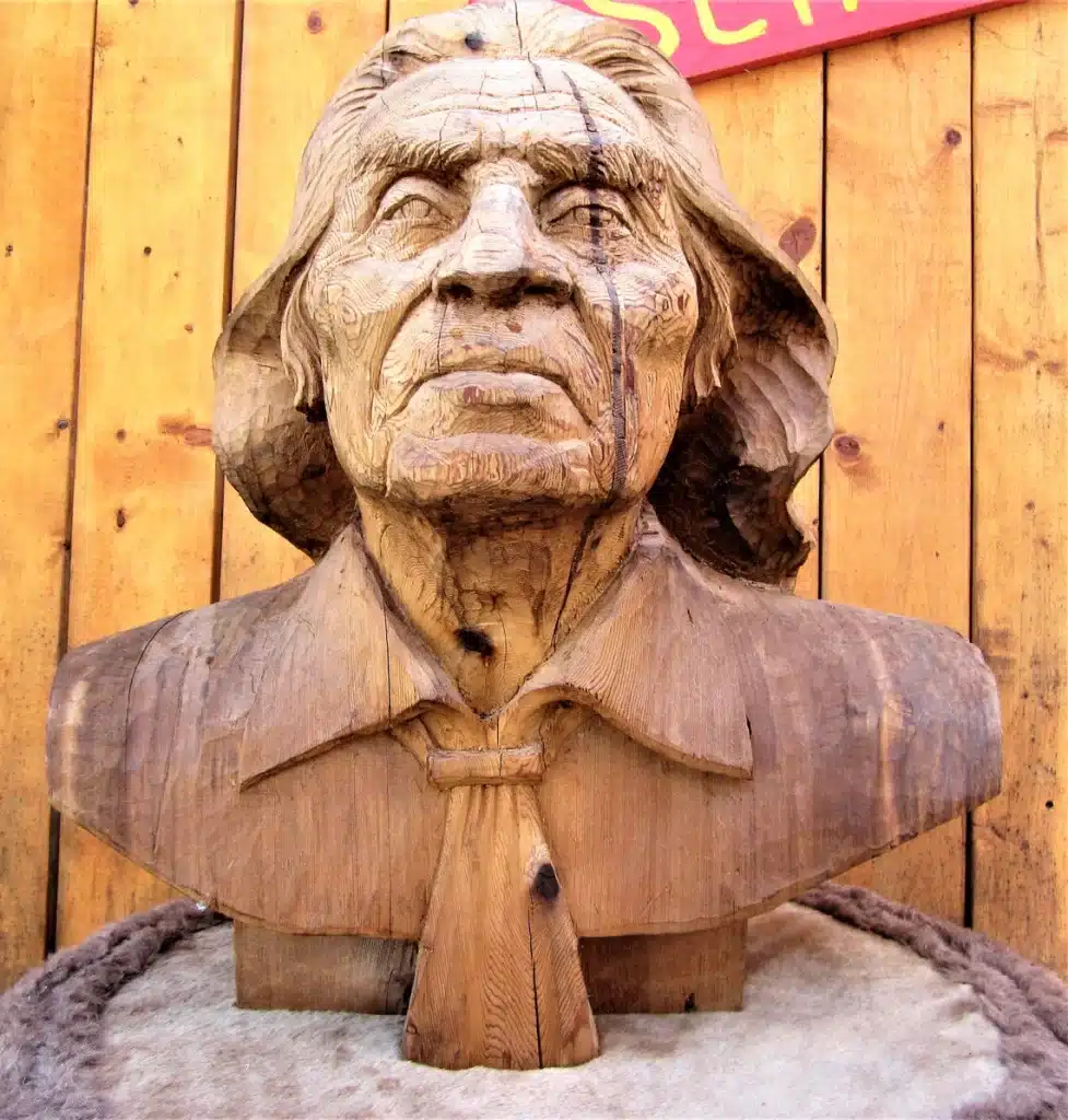 A wooden sculpture of Chief Dan George made out of cedar.