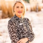 A picture of Shannon Luscombe in a black and white shirt in front of a field.