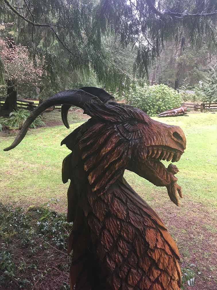 A dragon head and neck carved out of wood by Kevin Lewis. 