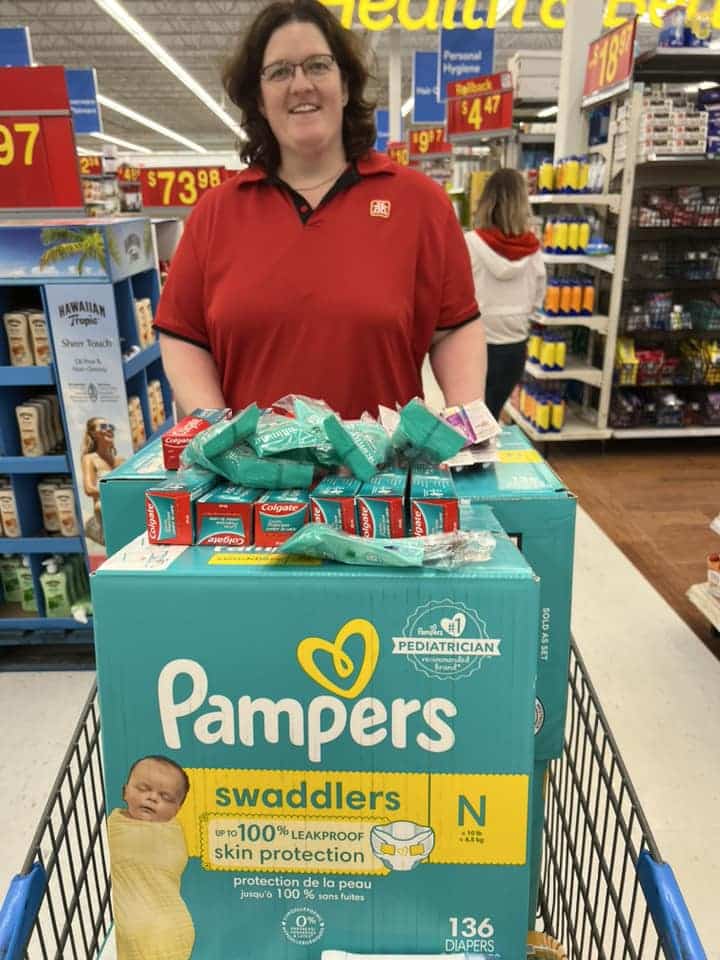 A Home Hardware employee with a cart full of baby essentials.