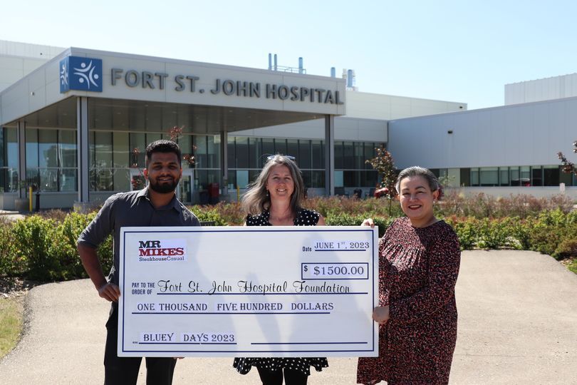 One man and two woman holding up a cheque from Mr. Mike's for the hospital foundation for the amount of $1,500